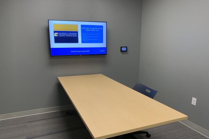 Lupton Hall's first floor study room, containing a table, chair, and monitor