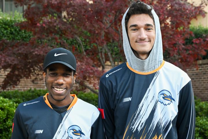 Two of the UTC Rocket League B team players pose in their jerseys.